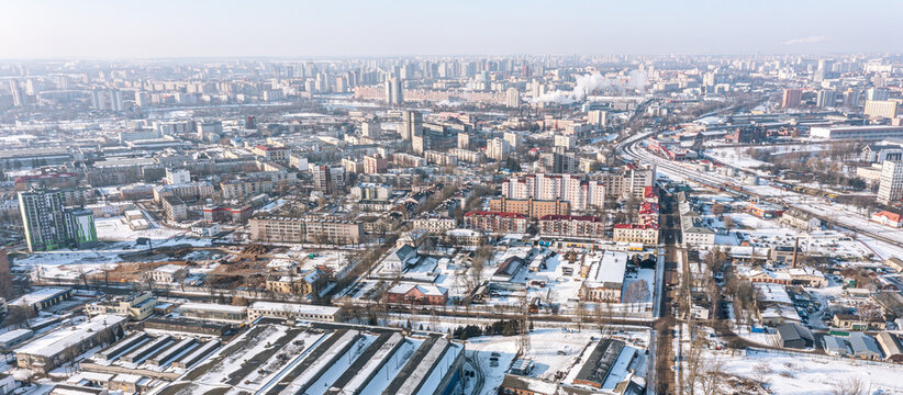 industrial district at city with warehouses and factory buildings. panoramic aerial view in winter time.