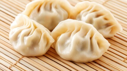 Delicious dumplings on a bamboo mat, showcasing their delicate folds and savory filling, perfect for a tasty meal or snack.