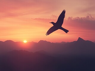 Fototapeta premium Silhouette bird flying over mountain range at vibrant sunrise.