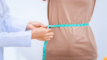 Female Asian nutritionist providing consultations for weight loss. reduce belly fat, offering advice on nutrients, metabolism, hydration, balanced diets to improve overall health and wellness.