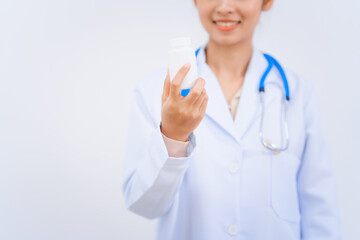 A young Asian nutritionist and doctor, smiling happily while wearing a stethoscope and white lab...