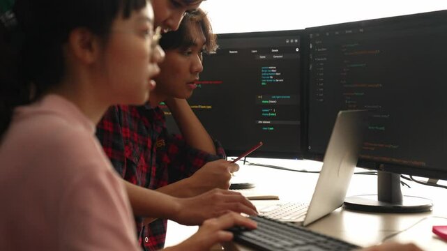 Slow motion back end software developer engineer for computer programming working together on debugging writing computing code, solving complex algorithms display on monitor in office. Burgeoning