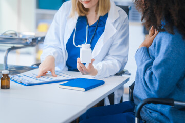 A young African American patient consults with a young Russian medical doctor about her immune system and vitamin intake. They discuss patient medical history,  vitamin and pill bottles on the desk.