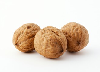 Three walnuts arranged on a white background. The walnuts are brown with textured shells. The lighting is bright and even, creating a clean, studio
