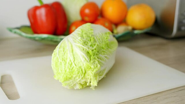 Close up of a Chinese lettuce in kitchen, healthy eating, vegetables for salad, vegan, vegetarian, wooden table, homemade