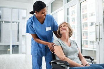 Obraz premium Caregiver, helping and elderly woman in wheelchair of rehabilitation, healthcare and injury recovery. Volunteer, mobility and patient with disability of healing care, medical service and nursing home