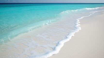 Turquoise waves gently kiss the sandy shore, embodying the serene essence of summer.