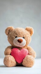 Cute teddy bear holding a pink heart on soft background