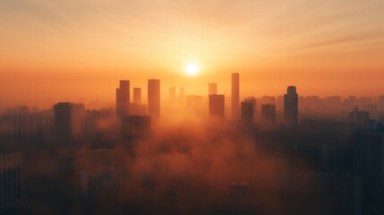 Fototapeta premium A breathtaking sunrise casts a warm glow over a city skyline, shrouded in mist, creating a serene and atmospheric landscape.