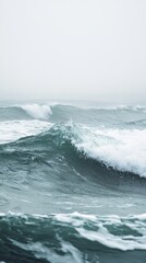 Fototapeta premium Serene Ocean Waves with Misty Background and Soft Color Palette