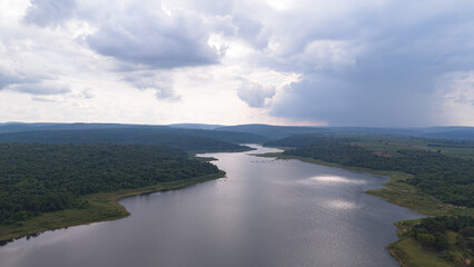 Drone shot. Aerial view scenic landscape of a large river delta amid a lush forest at the tropical...