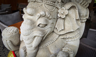 Garden Gnome traditional stone statue situated in a tranquil tropical garden, surrounded by vibrant foliage and artistic decor, harmonizing with the natural beauty of its environment