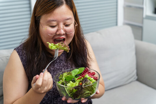 Asian Overweight woman dieting Weight loss eating fresh fresh homemade salad healthy eating concept Obese Woman with weight diet lifestyle.