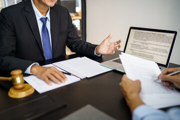 Lawyer Legal counsel presents to the client a signed contract with gavel and legal law. justice and lawyer Business partnership meeting concept.