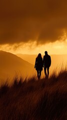 Fototapeta premium Couple silhouetted at sunset, mountain background, romantic hike
