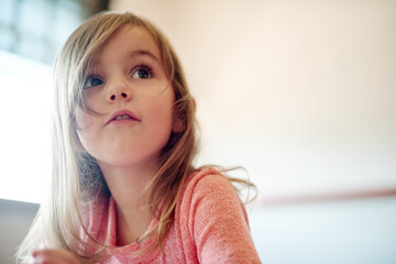 Imagination, thinking and wonder with girl in classroom at school for child development or growth. Future, idea and vision with kid student in academic class for education, learning or knowledge