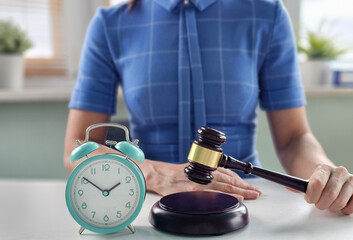 Clock and gavel symbolize the importance of time in legal proceedings at a law office