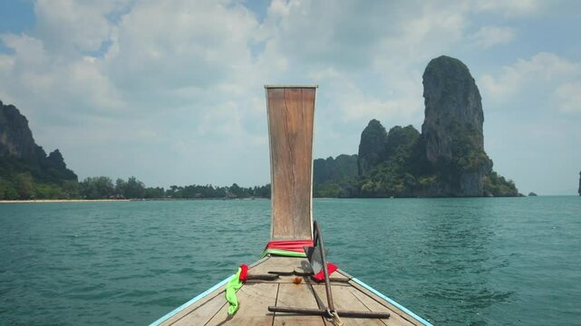Boat trip to the Railay beach, Thailand. Magnificent nature of Thailand. View on tropical beach and cliffs in thailand from the boat. Exploring exotic islands by boat