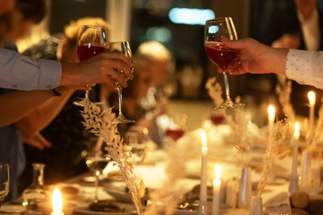 Celebrating with drinks at a festive dinner gathering in a cozy setting
