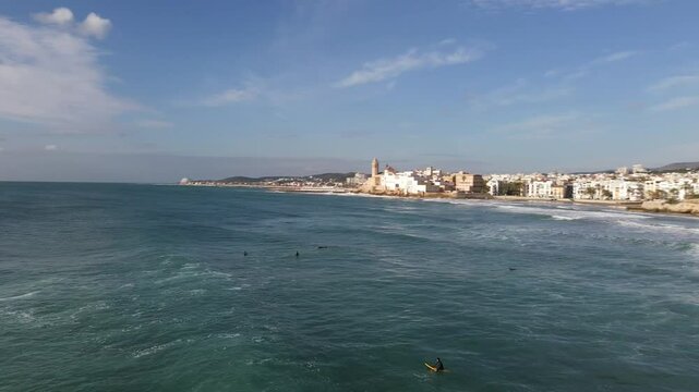 Surfers waiting for waves in sitges, spain