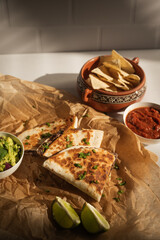 Mashed black bean quesadillas with guac, salsa, and tortilla chips