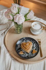 Heart shaped pancakes with sugar powder for surprise breakfast in bed