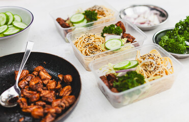 a table topped with plastic containers filled with food ingredients for healthy and balanced nutrition meal preparation for food delivery