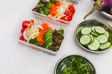 a table topped with plastic containers filled with food ingredients for healthy and balanced nutrition meal preparation for food delivery