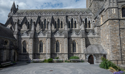 Christ Church Cathedral in Dublin with its Gothic architecture, arched windows, and stone facade, set against a partly cloudy sky