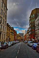City Street with Parked Cars and Varied Architecture in Manchester, UK