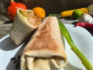 shawarma on a plate on a white plate . photos in high quality
