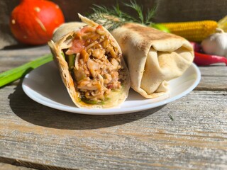 shawarma on a plate on a white plate . photos in high quality