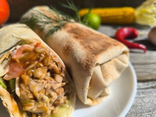 shawarma on a plate on a white plate . photos in high quality