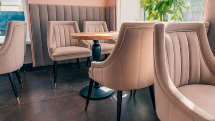 Empty beige upholstered chairs in a coffee shop in the morning