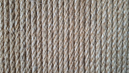 Rope knots background texture. Old brown rope is twist for background texture. Ropes arranged vertically.