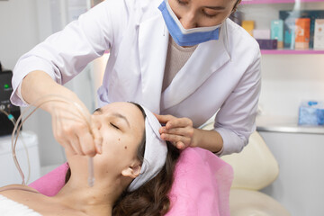 Face Beauty Treatment. Close up of female client getting facial gas-liquid oxygen water epidermal peeling using hardware apparatus