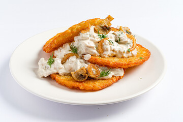 Golden, crispy potato pancakes are elegantly layered with a rich and creamy mushroom sauce. Garnished with fresh herbs, this dish offers a delightful flavor combination perfect for any meal. 