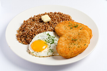 Savor a delightful breakfast made with crisp, golden patties beside a vibrant sunny-side up egg. 