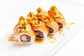 Colorful sushi rolls display a delightful arrangement of fresh fish and creamy wasabi, enhanced with a sprinkle of spices. 
