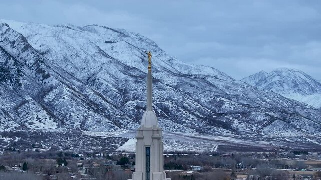 Aerial LDS Temple spire Payson Utah mountain circle 4K. The Church of Jesus Christ of Latter-day Saints, LDS or Mormon religion. Sacred building for eternal worship. Residential neighborhood.