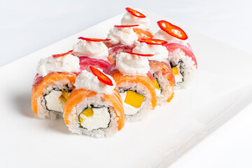 Colorful sushi rolls showcase layers of fresh fish and creamy filling, beautifully arranged and...