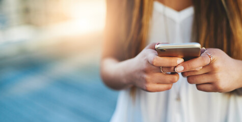 Woman, hands and phone on vacation in city, urban tourist and online for social media update. Female person, holiday location and internet for guidance on trip, texting and app for communication