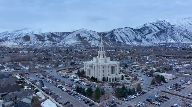 Aerial LDS Temple Payson Utah mountain valley circle 4 4K. The Church of Jesus Christ of Latter-day Saints, LDS or Mormon religion. Sacred building for eternal worship. Residential neighborhood.