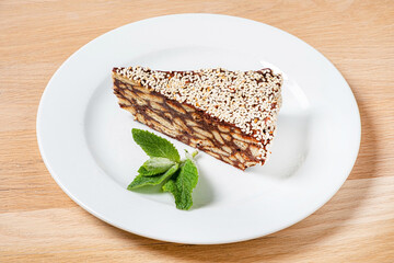 Enjoying a delectable slice of a layered dessert adorned with sesame seeds, resting elegantly on a...