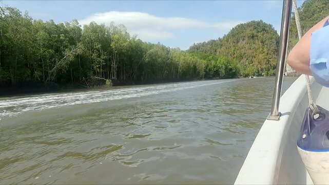 POV fast boats traveling down tropical waterways in Langkawi Malaysia