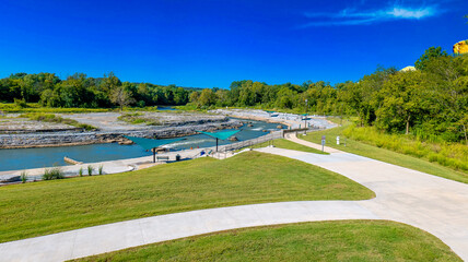 Fototapeta premium Scenic Riverside Park with Walking Paths
