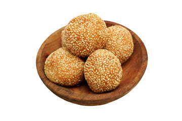 White isolated photo of sesame balls or onde-onde. Onde-onde is one type of traditional Indonesian cake that is popular in various regions with sweet filling, on a wooden plate.