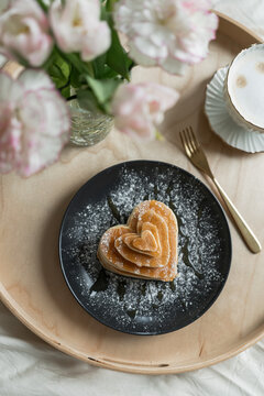 High angle closeup heart shaped tasty pancakes for romantic breakfast
