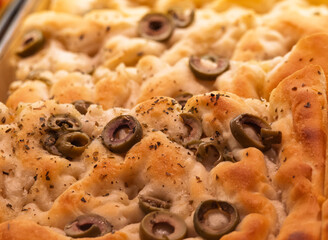 Ligurian focaccia with vegetables and pesto sauce in a shop