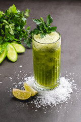 Refreshing green detox drink with cucumber, lime, and parsley